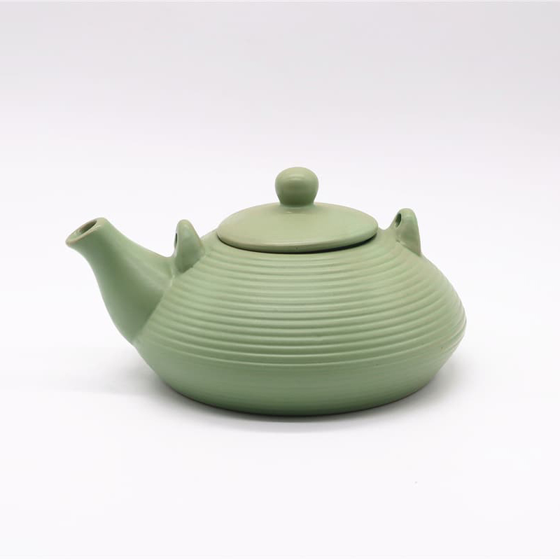 What problems might arise from different shrinkage rates during the firing of a ceramic teapot?